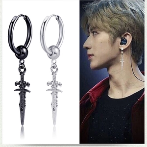 Close-up of vintage punk cross sword earrings in black and silver finishes on male model
