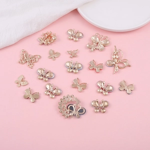 Golden butterfly charms with blue enamel details for DIY phone case and jewelry making