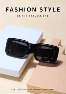 Detail of vintage small rectangular sunglasses with thick black frame on geometric props