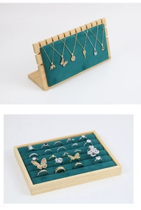 Close-up of bamboo wood jewelry stand with green velvet lining for necklaces and rings