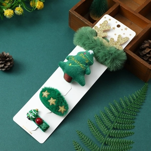 Detail of Christmas gift hair set with plush elk and tree clips in holiday scene