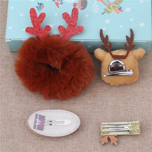 Detail showing plush reindeer hair clips and glitter hairpins for Christmas gift set