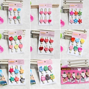 Set of decorative wooden clips with cartoon shapes like mushrooms and hearts for photo walls