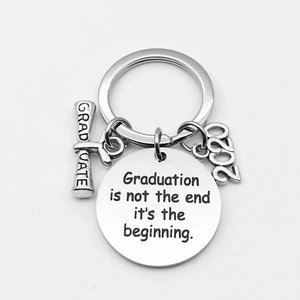 Macro detail of stainless steel graduation keychain with 2020 charm and engraved quote