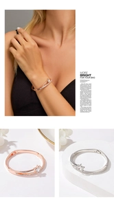Detail of rose gold and silver star heart bracelets with rhinestone inlay on model