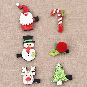 Detail of 6-piece Christmas glitter felt hair clips featuring Santa and reindeer on linen