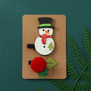Christmas hair clip set featuring glitter snowman and holly berry on festive display card