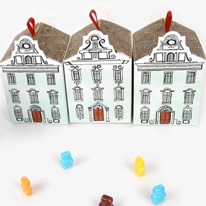European style house shaped gift boxes with red ribbons and colorful gummy bears