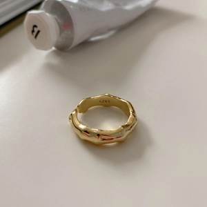 Macro shot of 925 sterling silver ring with gold finish and wave texture detail