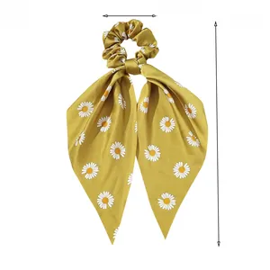 Detail of mustard yellow daisy print satin hair tie with 38cm long ribbon streamer