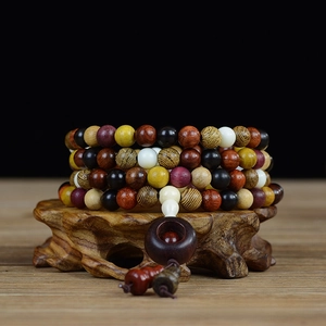 Macro detail of 108 mixed hardwood prayer beads with gourd pendant and wooden ring