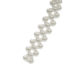 Close-up of white elastic pearl waist chain showing glossy beads for dresses