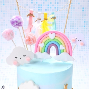 Rainbow and cloud cake topper set with soft clay arch, smiling clouds and fuzzy pom-poms