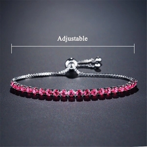 Adjustable silver tennis bracelet featuring pink rhinestones and a slider clasp detail