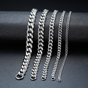 Silver stainless steel Cuban link bracelets in five different widths on black leather stand