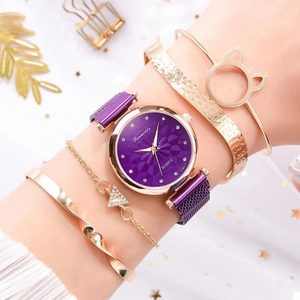 Close-up of purple mesh watch with gold cat-ear bracelets on elegant star background