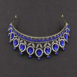 Macro shot of bronze bridal tiara featuring blue teardrop rhinestones and clear crystals