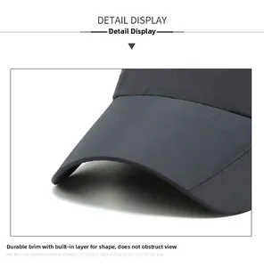 Detail of hard structured brim and breathable laser-cut holes on dark grey baseball cap