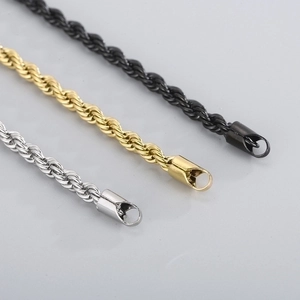Macro detail of silver, gold, and black rope chains with secure lobster claw clasps