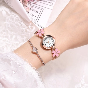Elegant rose gold women's watch with pink floral band and matching heart crystal bracelet