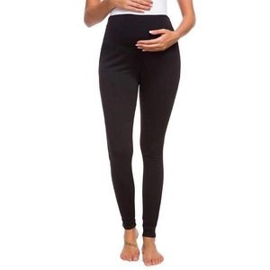 Detail view of high waist maternity leggings featuring elastic belly support in black