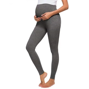 Detail of dark grey maternity leggings showing high waist support and elastic fabric texture