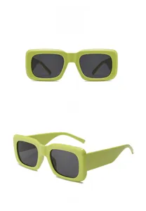 Macro detail of rectangle sunglasses with bright lime green frames and dark gray lenses
