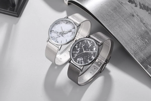 Detail of marble dial watches in silver and grey with Milanese mesh strap on magazine