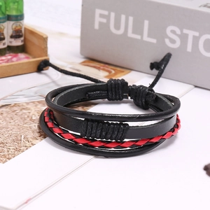 Close-up of layered black and red braided leather bracelet with adjustable cord