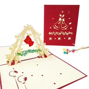 3D pop-up Christmas card detail showing laser-cut bell design and red festive cover