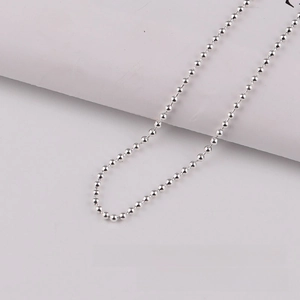 Macro shot of 3.2mm silver metal bead chain necklace with polished reflective finish