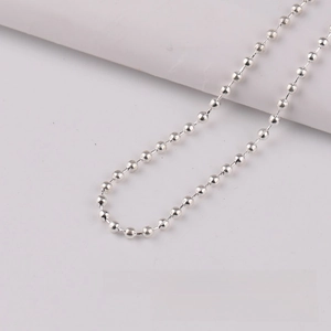 Macro view of 3.2mm silver bead chain necklace showing metallic texture and smooth finish