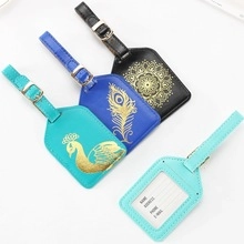 Group of four leather luggage tags with mandala patterns and personal info card slots