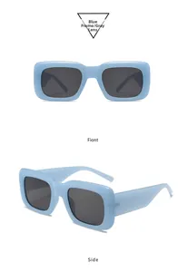 Detail view of light blue rectangular sunglasses with gray lenses and thick temples