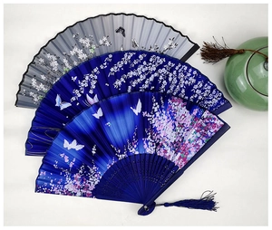 Three traditional silk folding fans with butterfly patterns and elegant tassels on white background