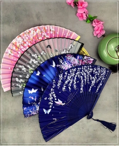Group of elegant Chinese silk folding fans with floral patterns and delicate tassels