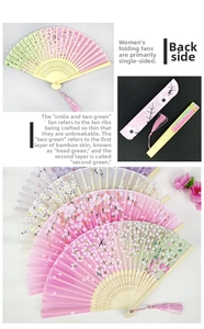 Detail of silk folding fan with bamboo hollow ribs, floral patterns and pink tassel charm