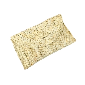 Handwoven corn husk straw envelope clutch bag in natural beige with flap closure