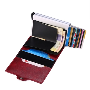 Detail of red leather wallet with silver automatic pop-up card mechanism and cash clip