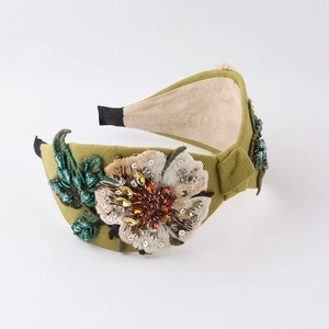 Detail of bohemian floral headband with embroidered petals and sparkling rhinestones