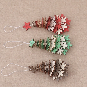 Three-piece wooden Christmas tree ornaments with stars and bells on beige linen cloth