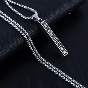 Retro stainless steel necklace with engraved rectangular pendant on dark texture