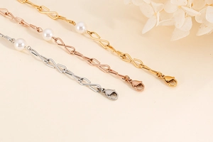 Detailansicht von Sternketten in Silber, Roségold und Gold mit weißen Perlen