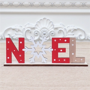 Detail of wooden NOEL Christmas table sign with snowflake icon and rustic star patterns