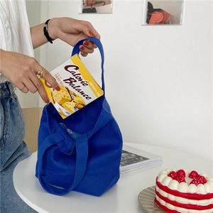 Blue canvas tote bag showing spacious interior with cookies for daily lifestyle use