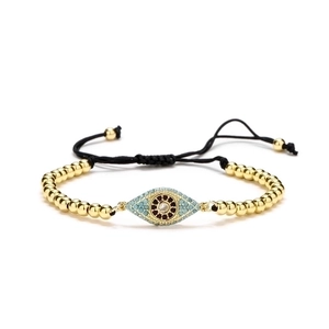 Adjustable woven evil eye bracelet with gold beads and blue zircon accents