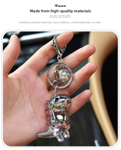 Detail of iridescent acrylic dinosaur keychain with holographic finish and star bead