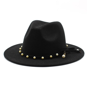 Close-up of black fedora wool hat featuring elegant pearl band and pendant detail