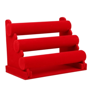 Three-tier red velvet jewelry display stand for bracelets and watches on white background
