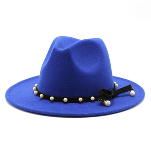 Detail of royal blue wool fedora with black ribbon, white pearls and side bow tassel